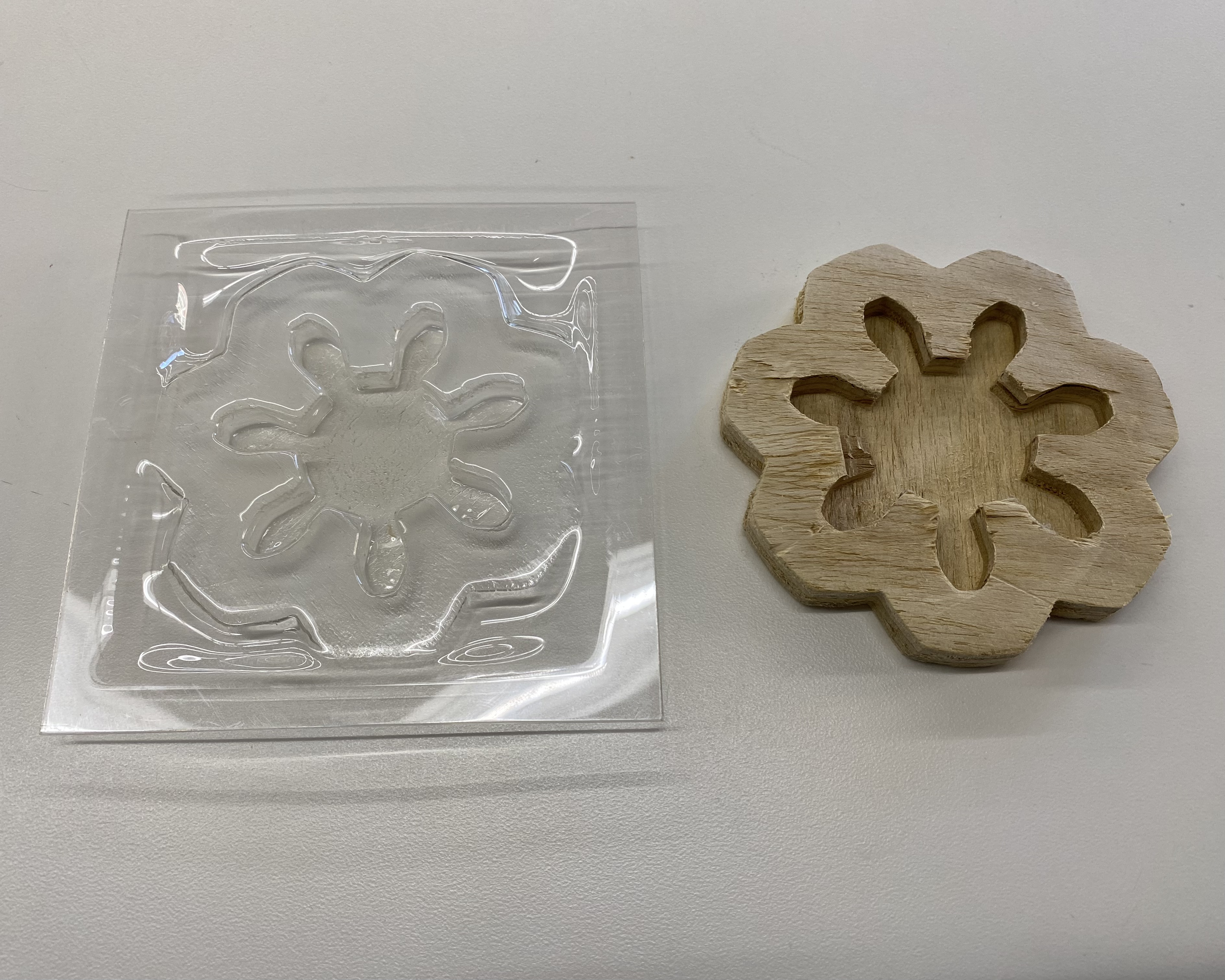 vacuum formed plastic and piece of wood side by side